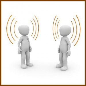 Two people are talking to each other with sound waves coming from their ears.