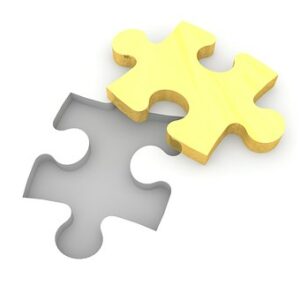 yellow puzzle piece next to spot on white background